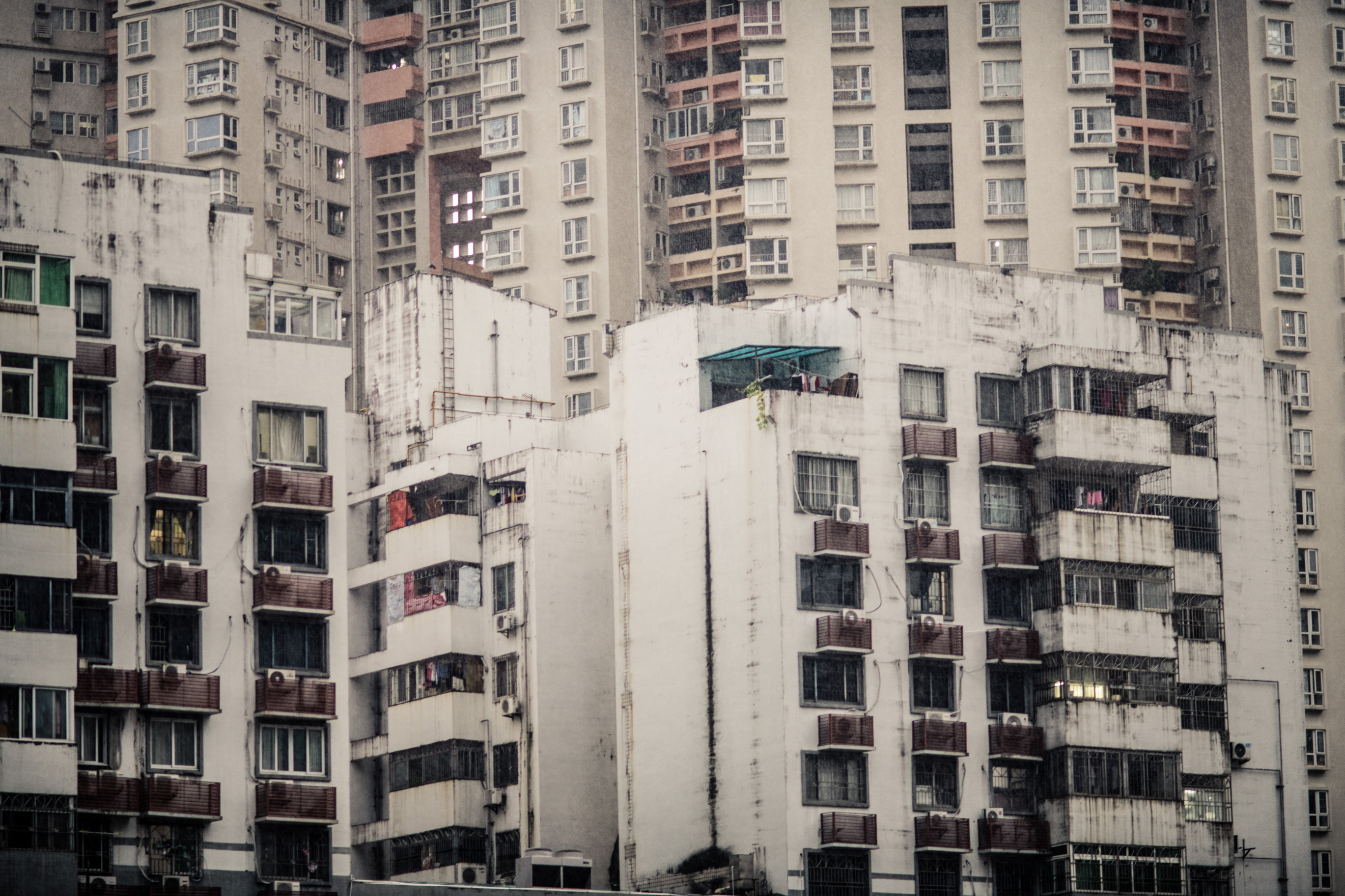 Des immeubles d'habitation blancs de hauteurs variées, des tours derrière eux